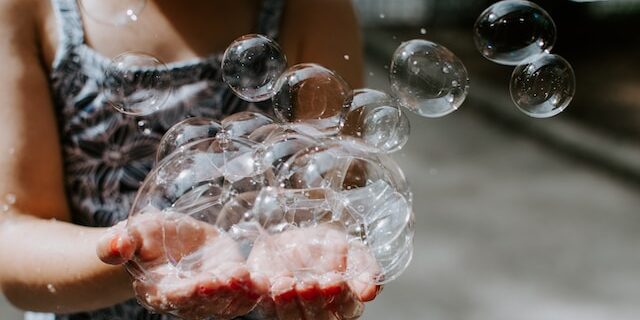 Girl holding soap bubbles