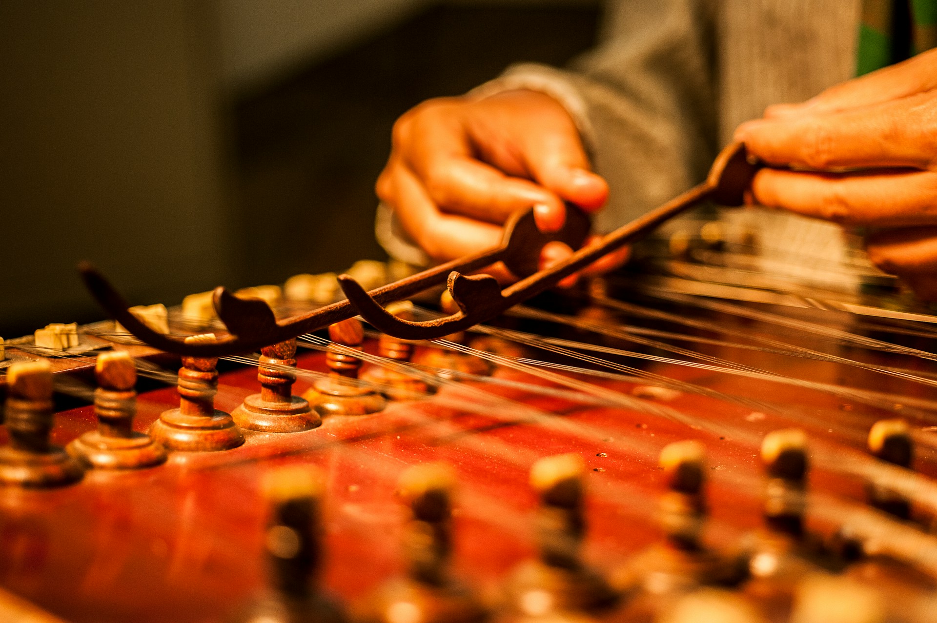 A person playing the santoor